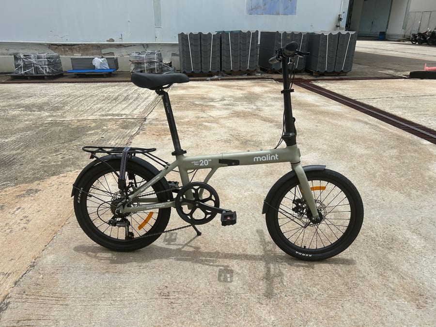 Urban Flex in khaki, drive side, parked on a concrete forecourt