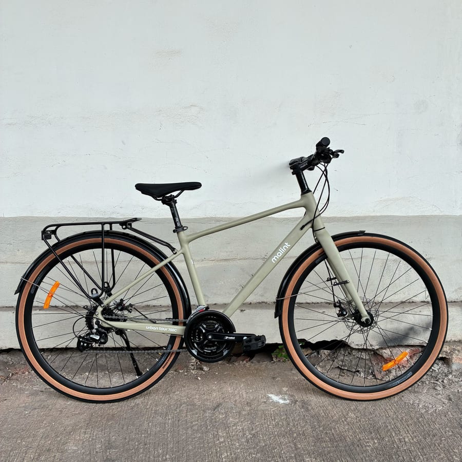 Urban Tour in khaki, drive side, against a wall